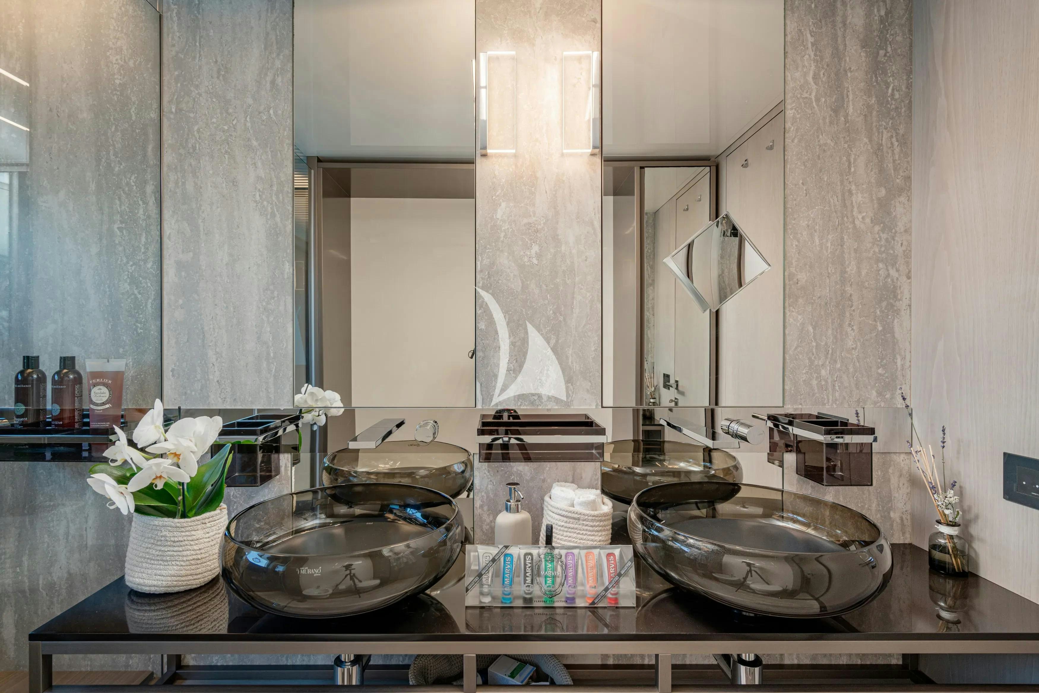 a bathroom with sinks and mirrors aboard E3 Yacht for Charter