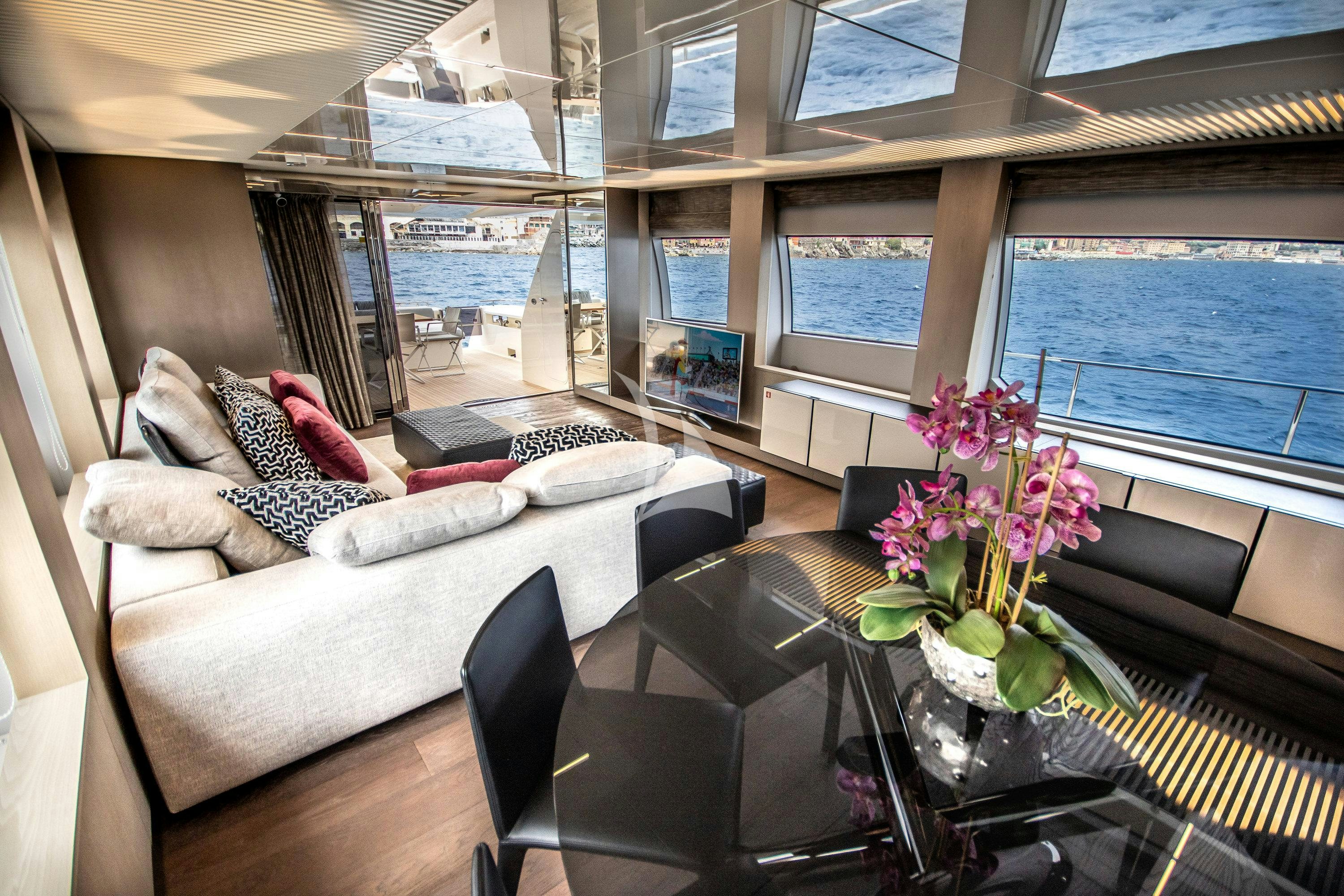 a living room with a large window aboard E3 Yacht for Charter