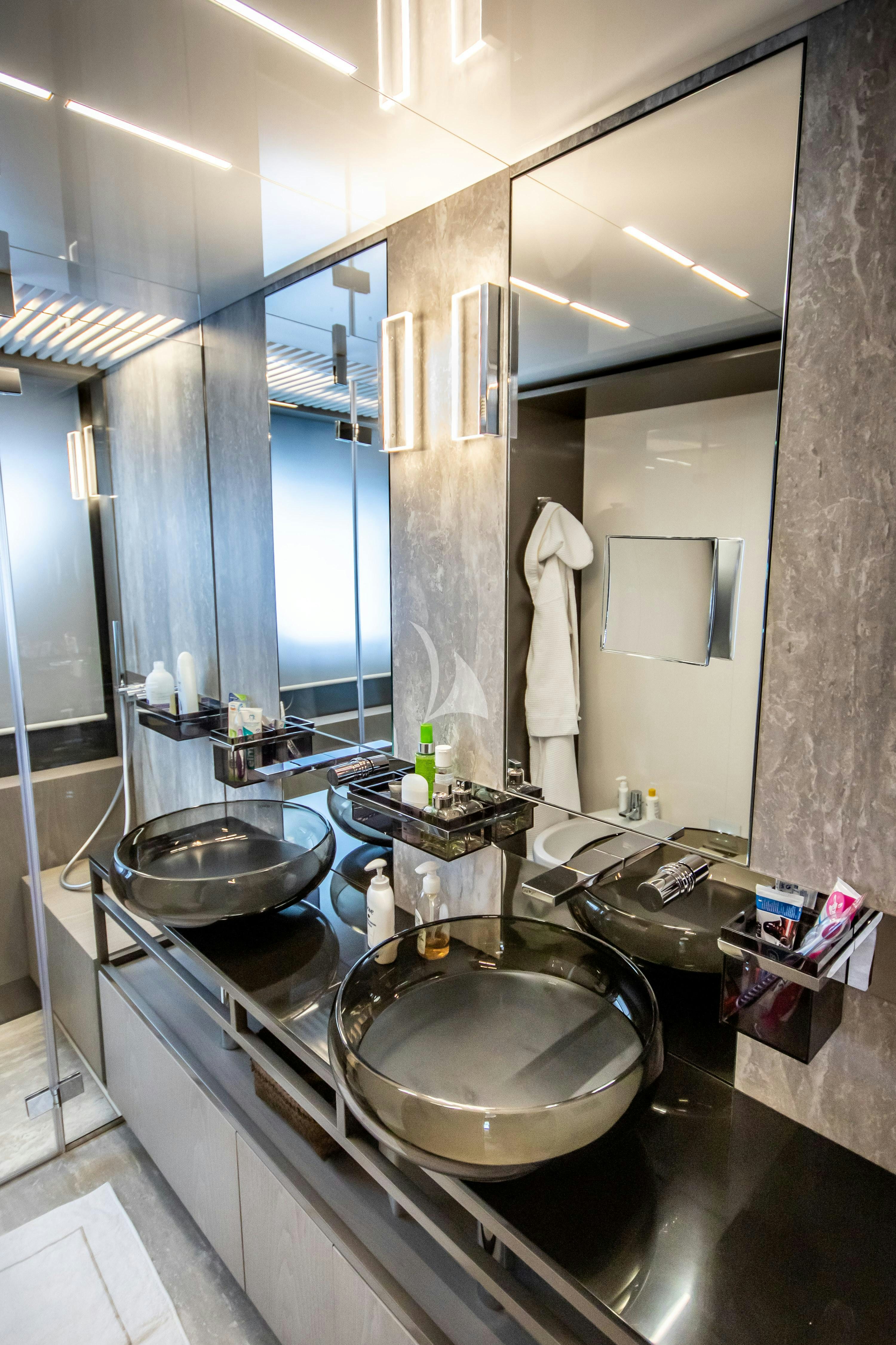 a bathroom with a large mirror aboard E3 Yacht for Charter