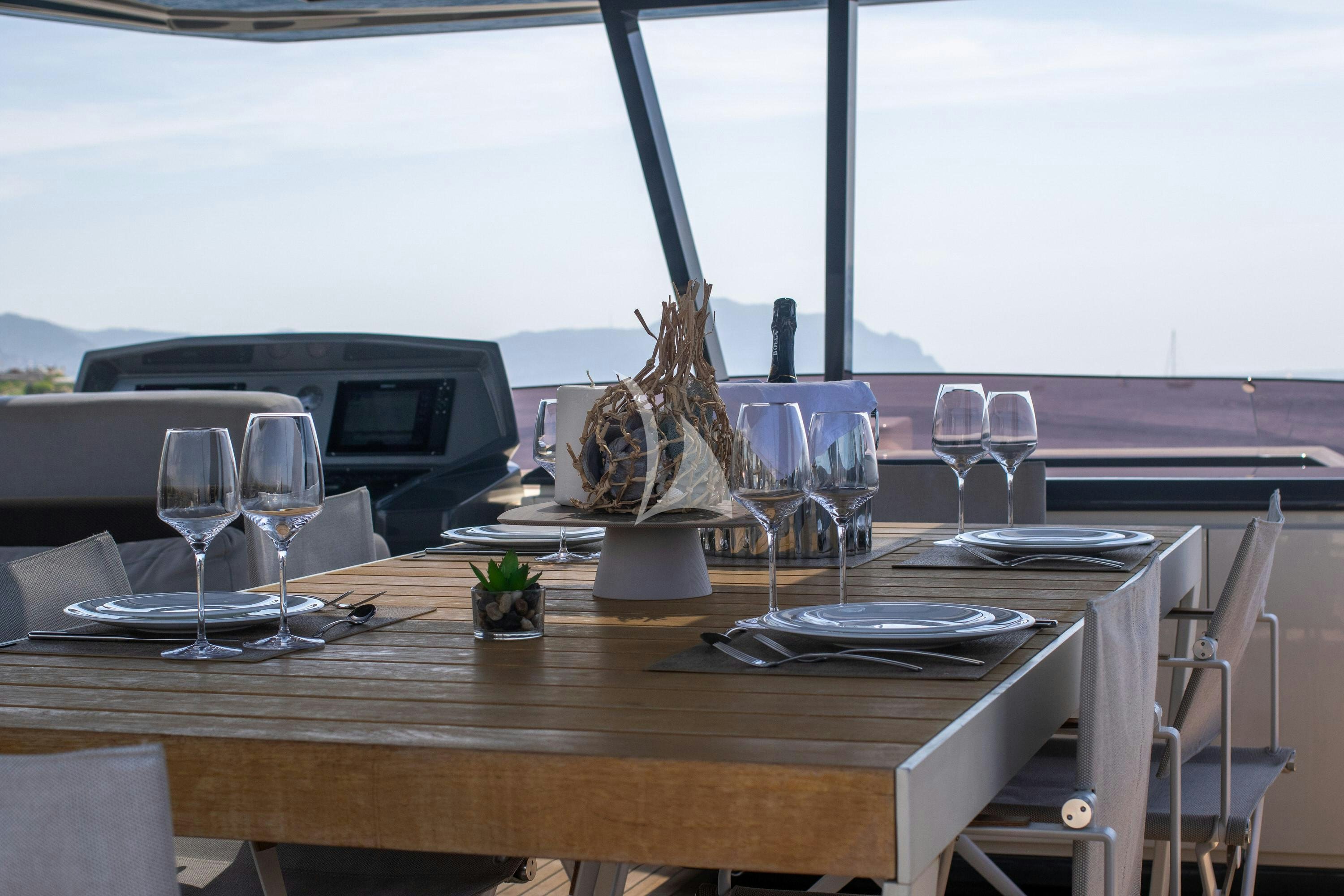a table with wine glasses and a cactus on it aboard E3 Yacht for Charter