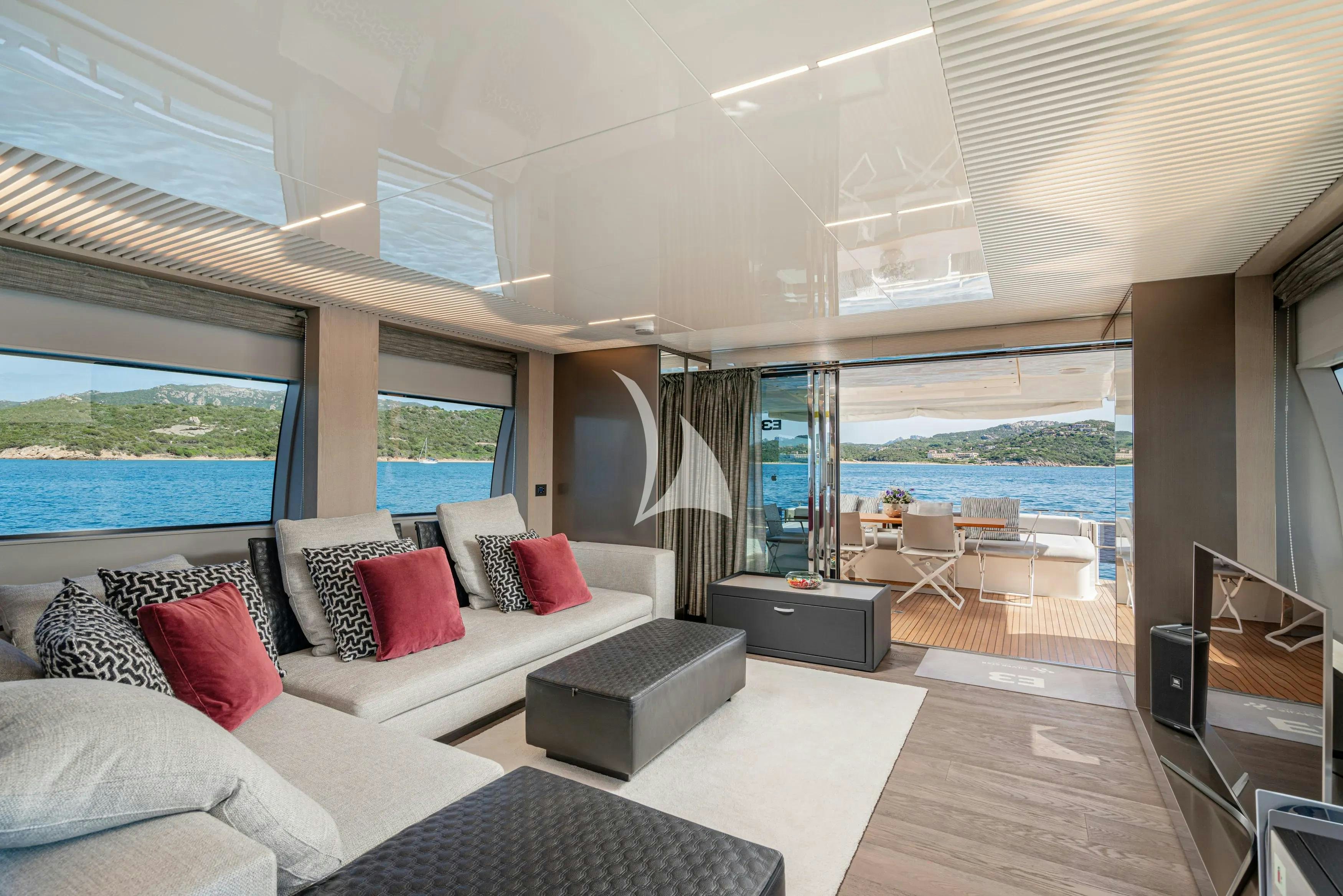 a living room with a large window aboard E3 Yacht for Charter