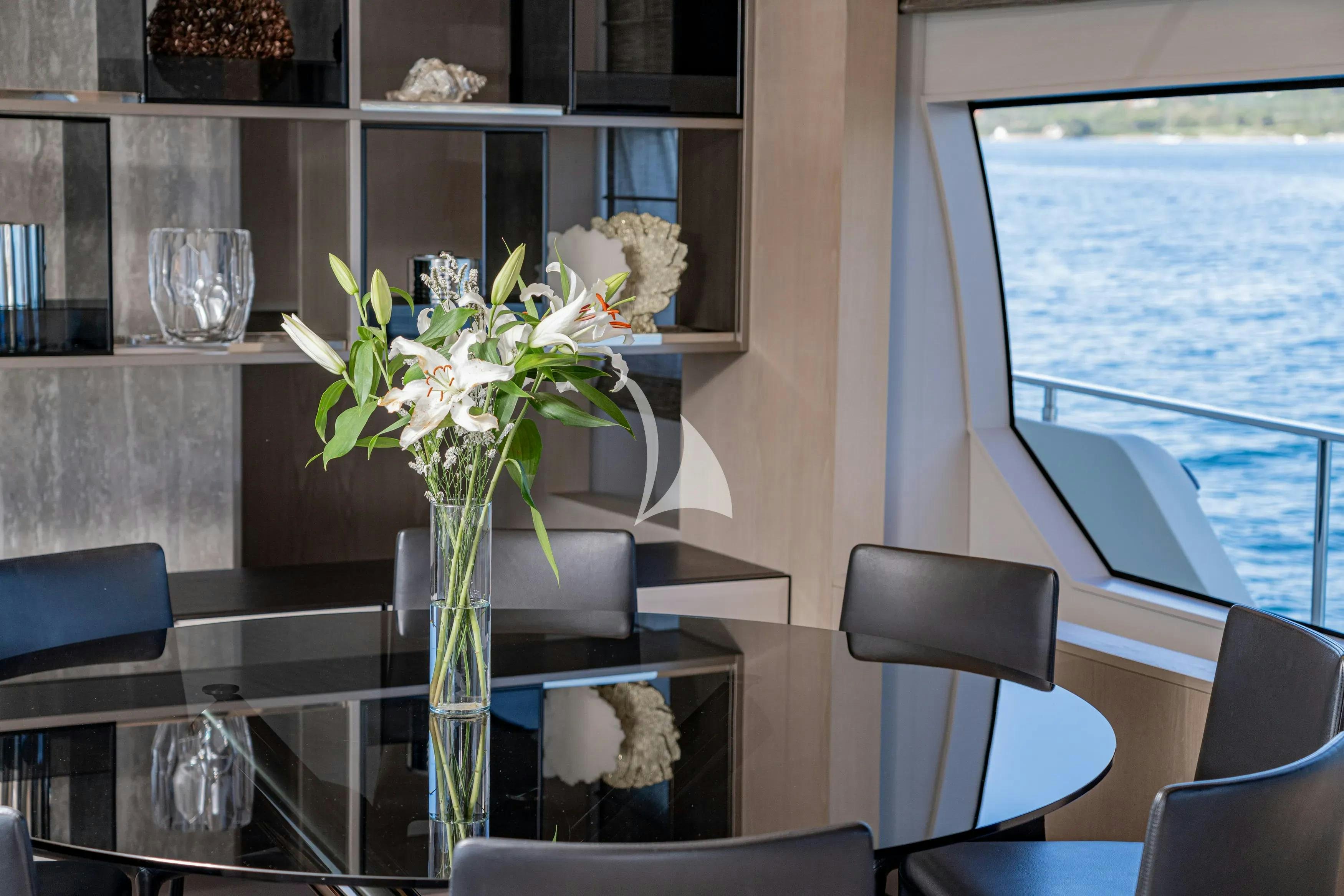 a vase with flowers on a table aboard E3 Yacht for Charter