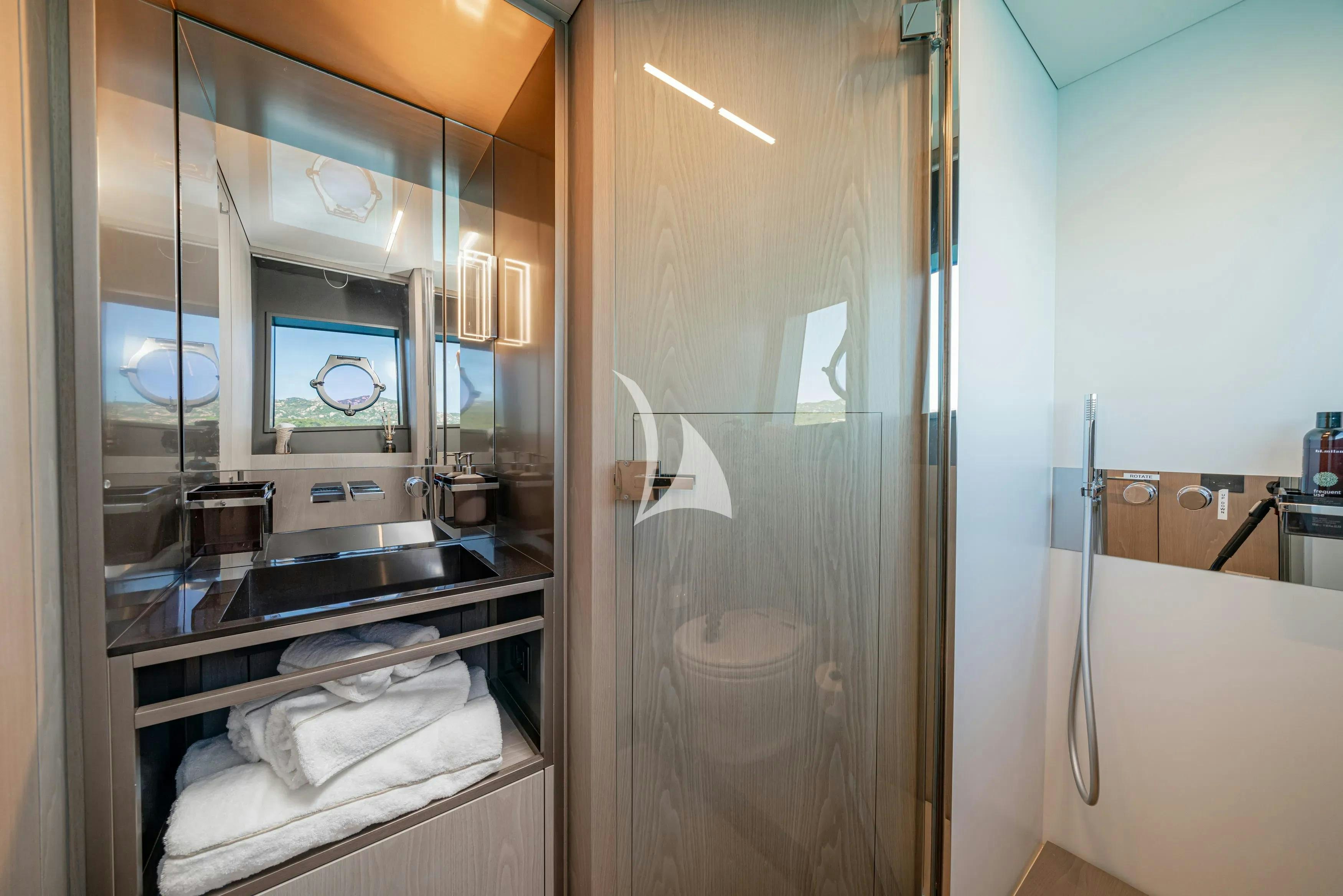 a bathroom with a glass shower aboard E3 Yacht for Charter