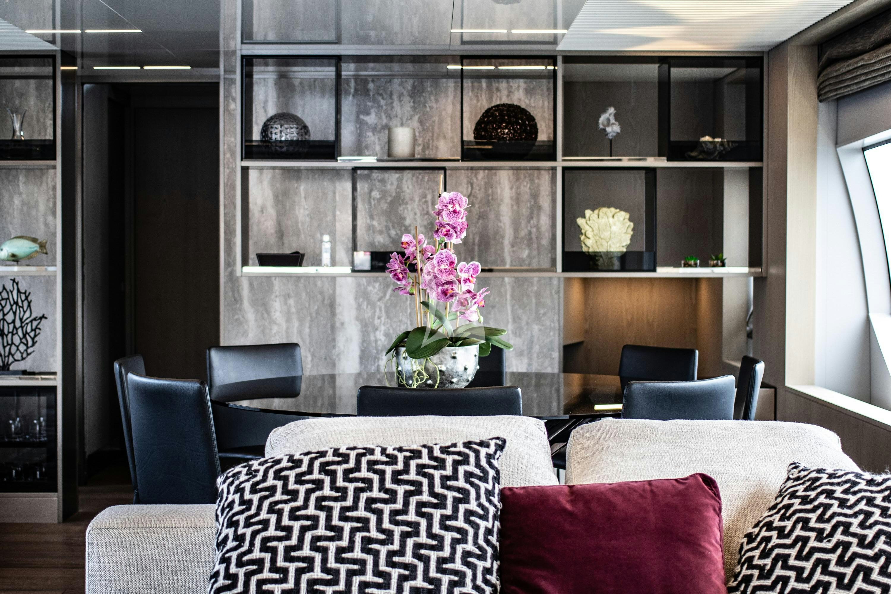 a room with a shelf and chairs aboard E3 Yacht for Charter