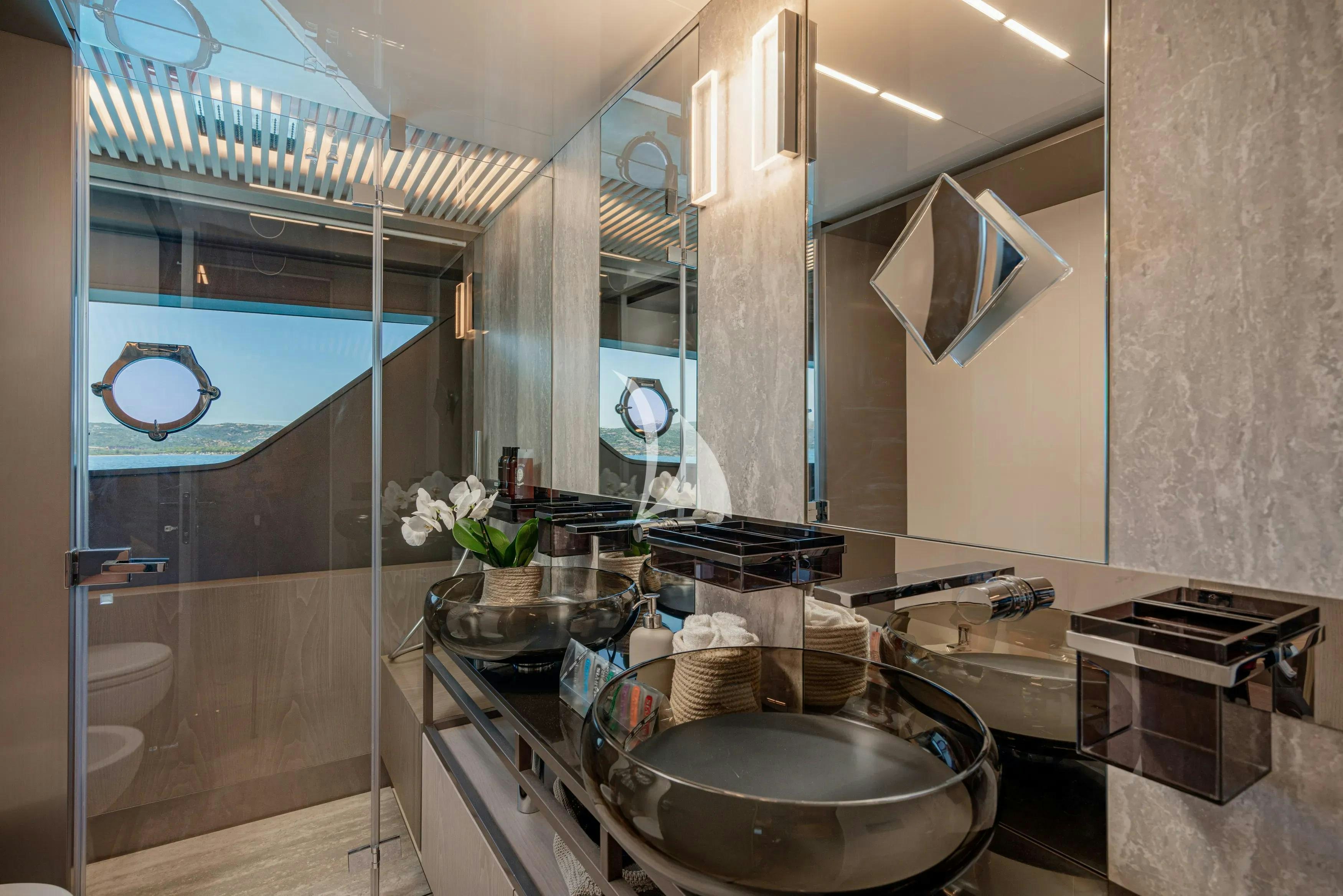 a bathroom with a sink and a mirror aboard E3 Yacht for Charter