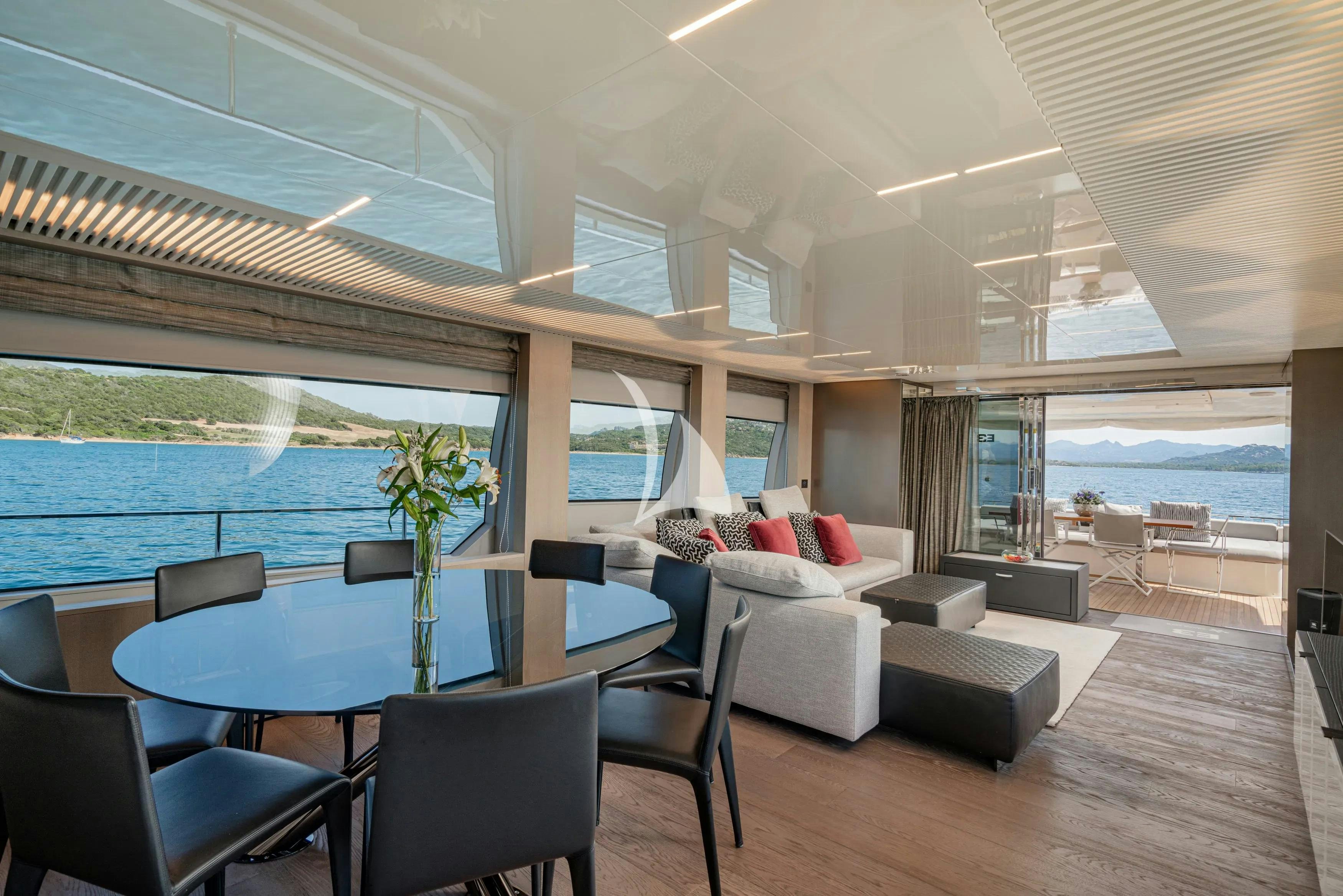 a room with a table and chairs aboard E3 Yacht for Charter