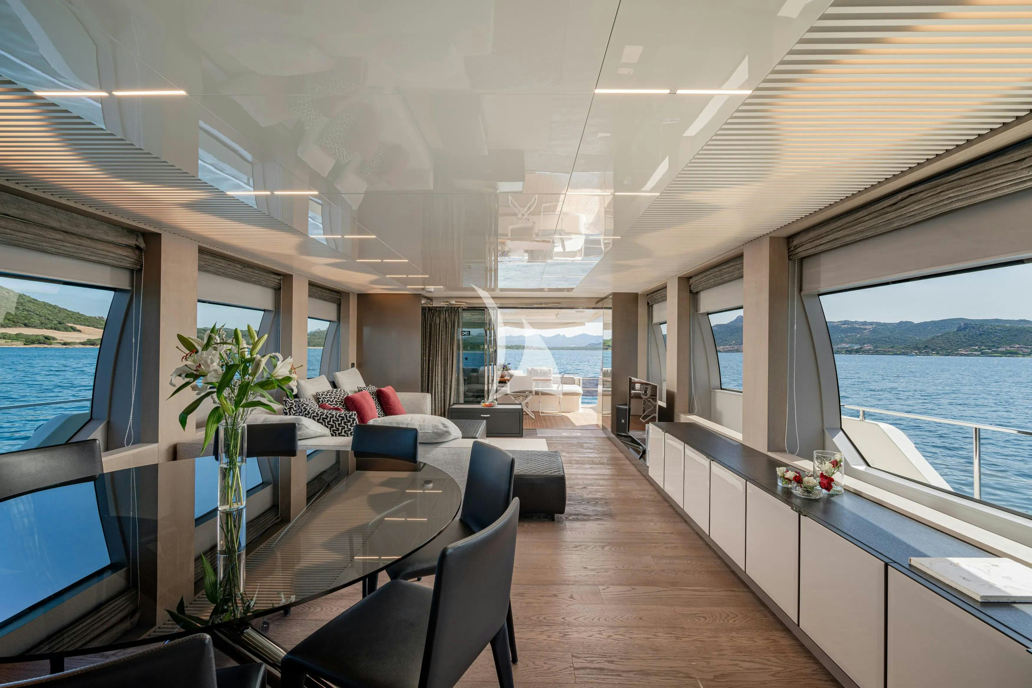 a room with a table and chairs aboard E3 Yacht for Charter