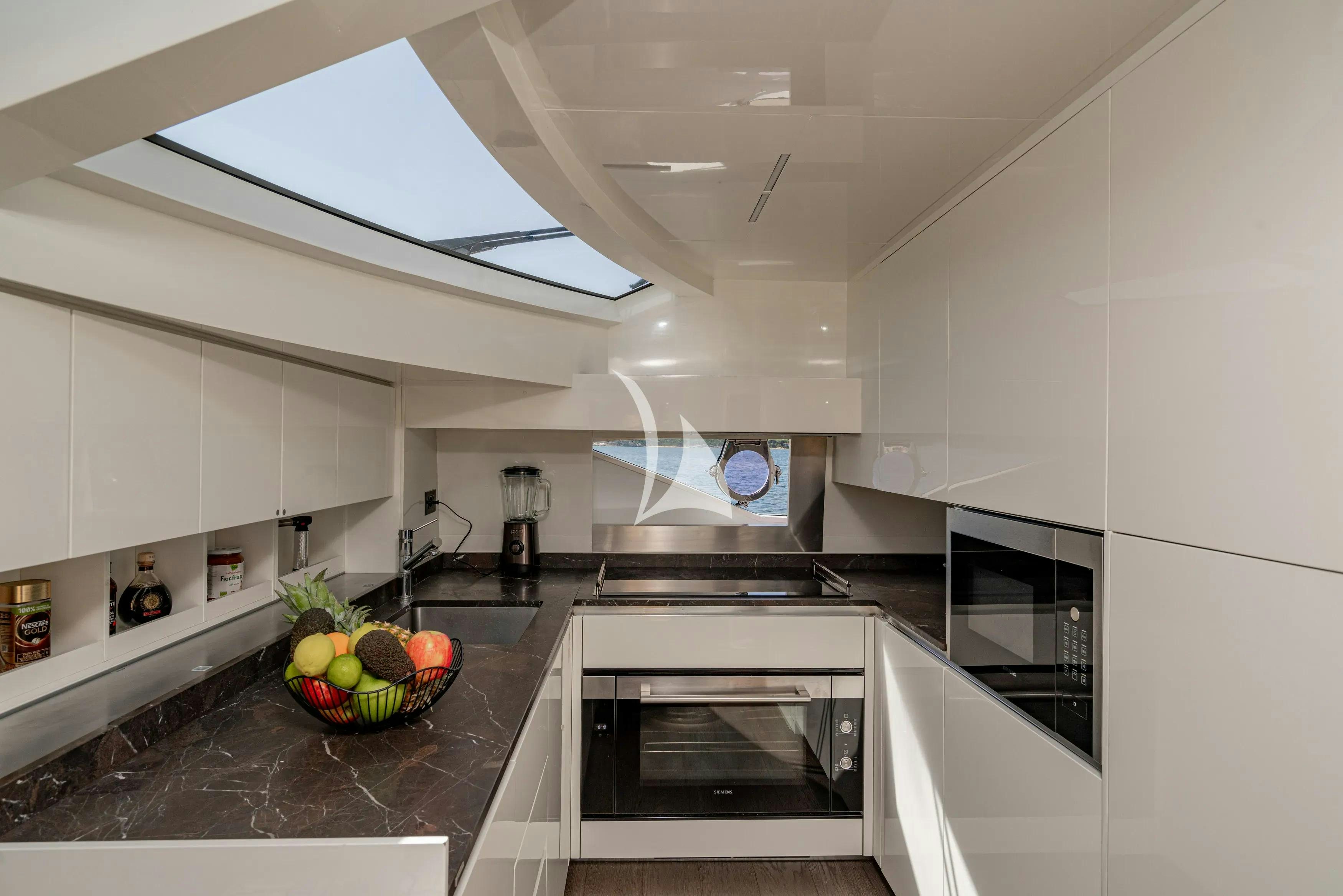 a kitchen with white cabinets aboard E3 Yacht for Charter