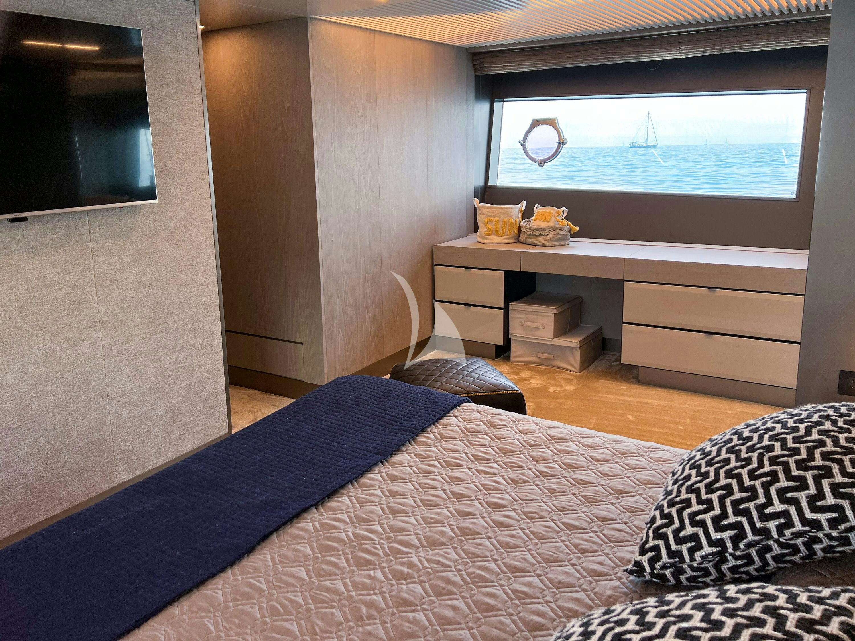 a bedroom with a bed and a desk aboard E3 Yacht for Charter