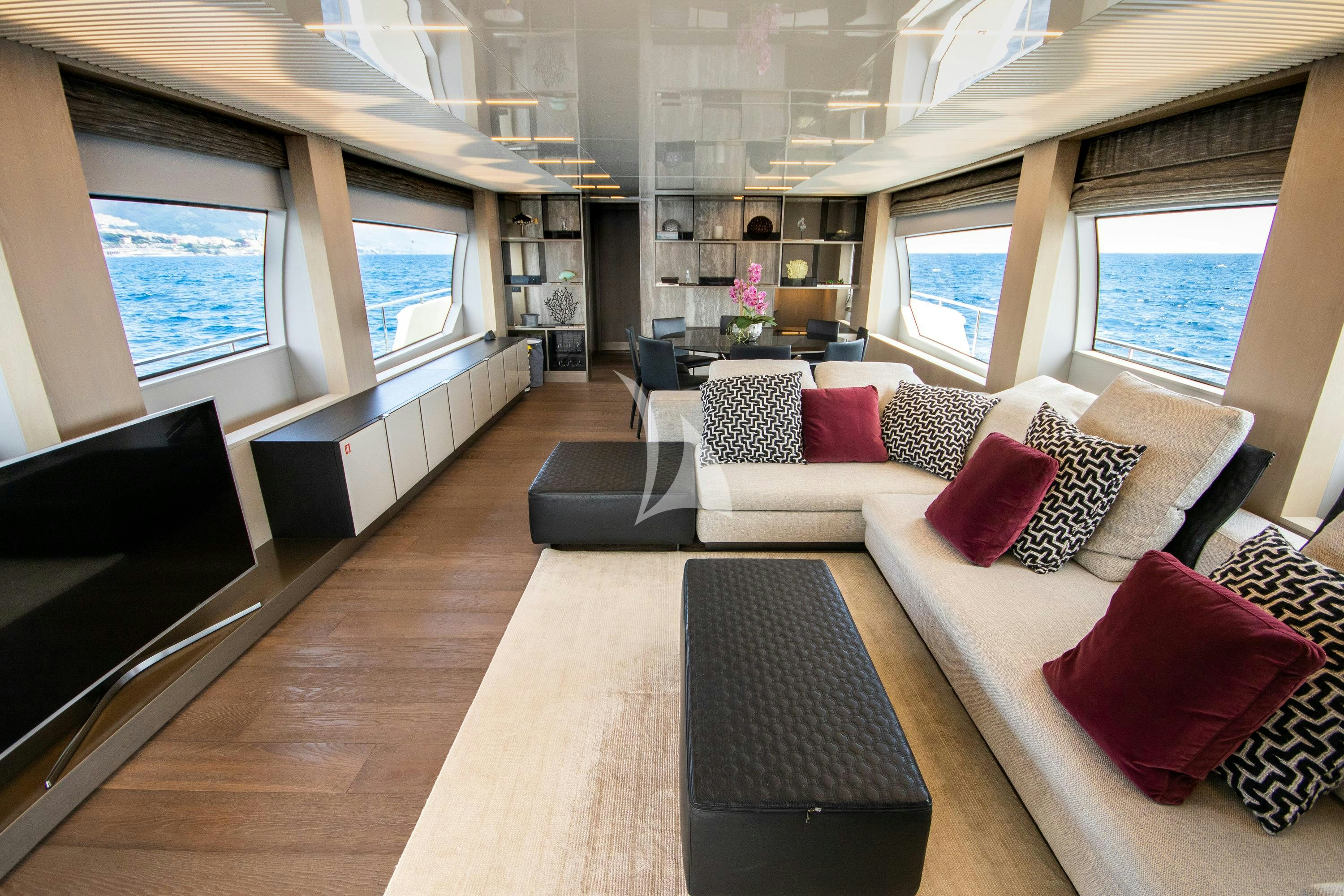 a living room with a large window aboard E3 Yacht for Charter