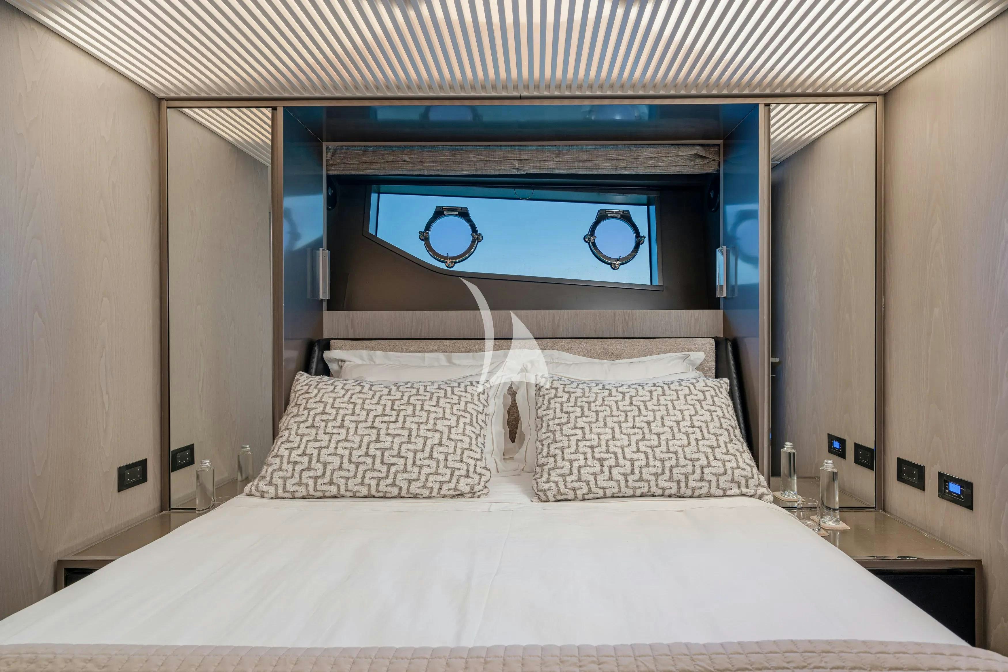 a bed with white sheets aboard E3 Yacht for Charter