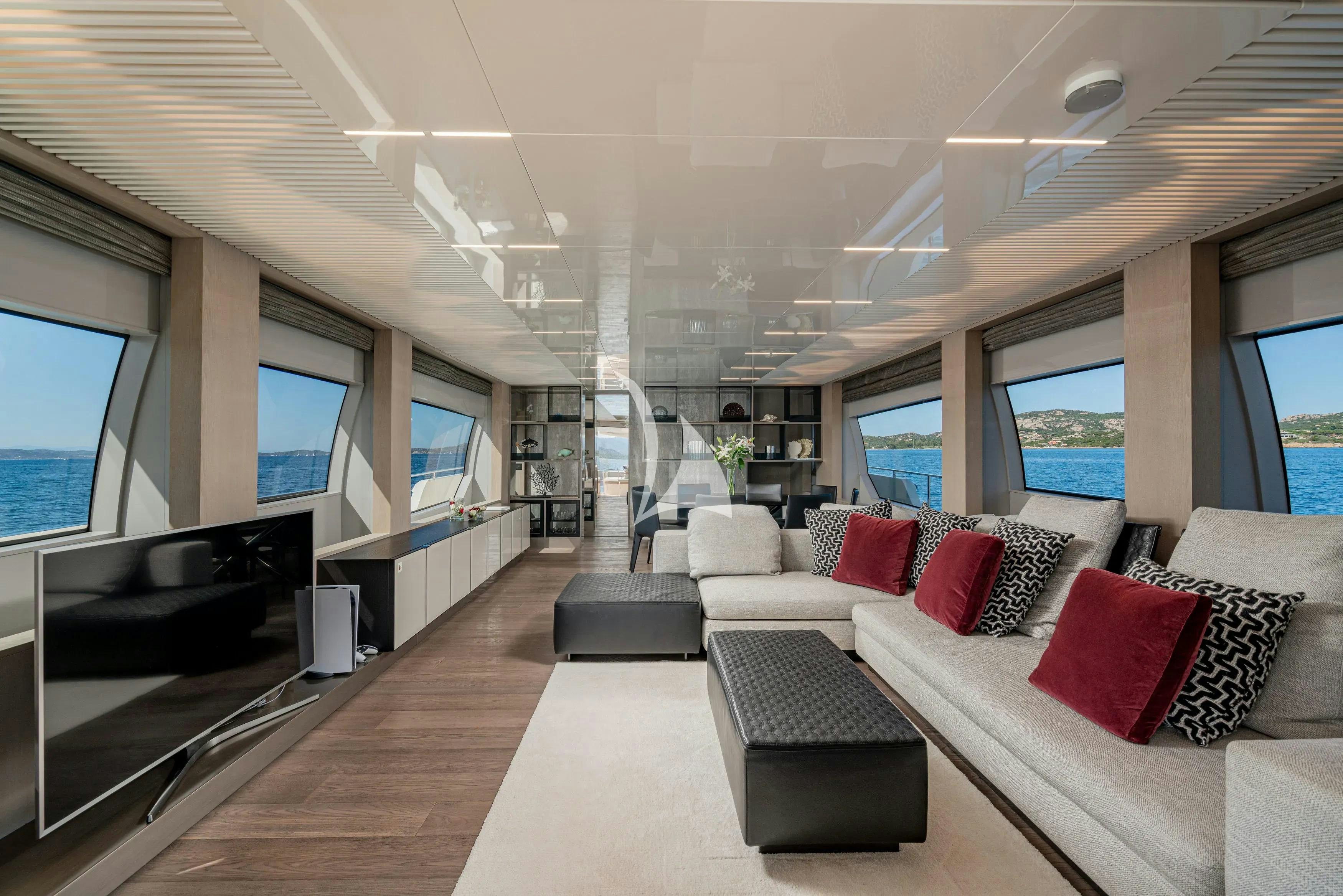 a living room with a large window aboard E3 Yacht for Charter