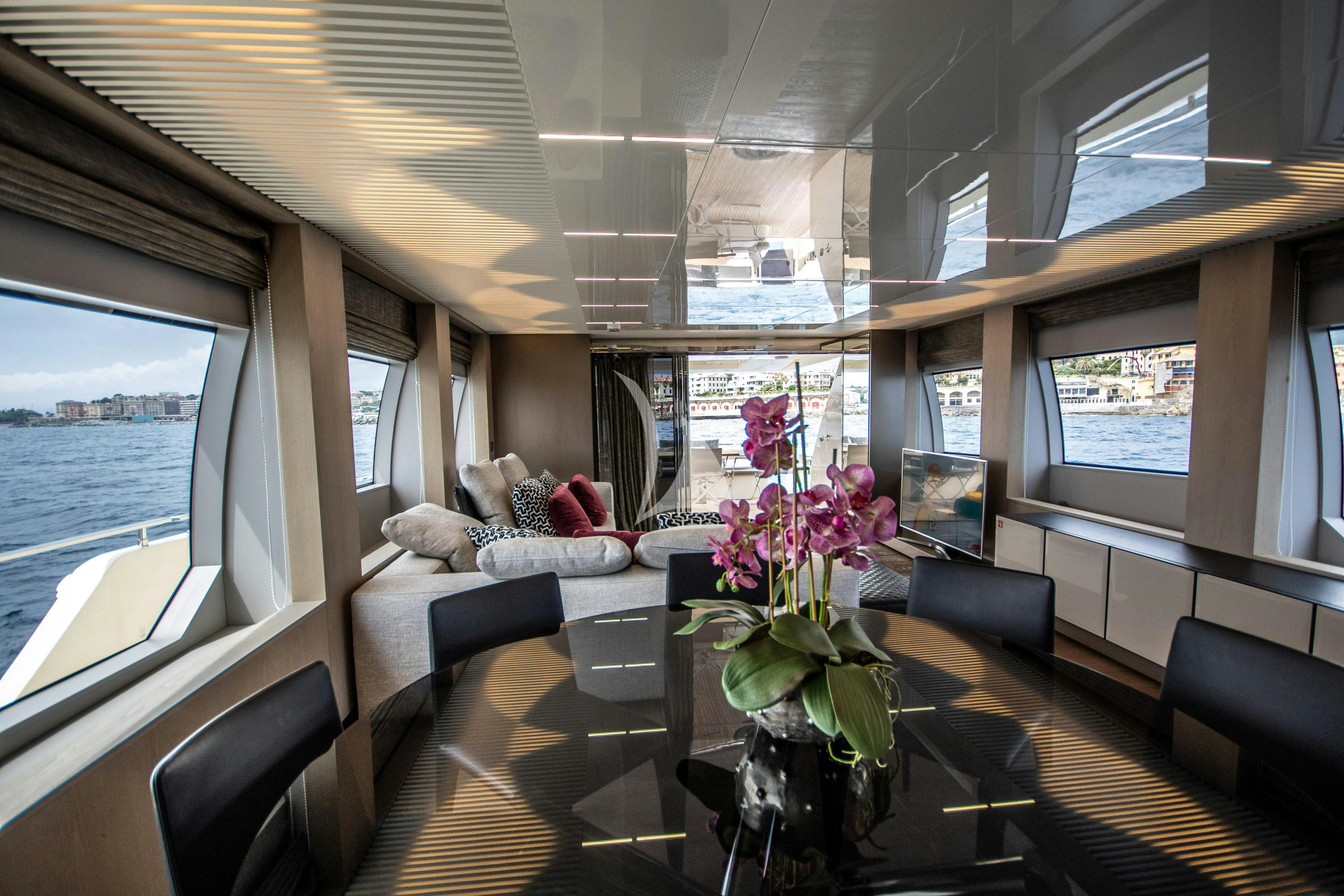 a living room with a large window aboard E3 Yacht for Charter