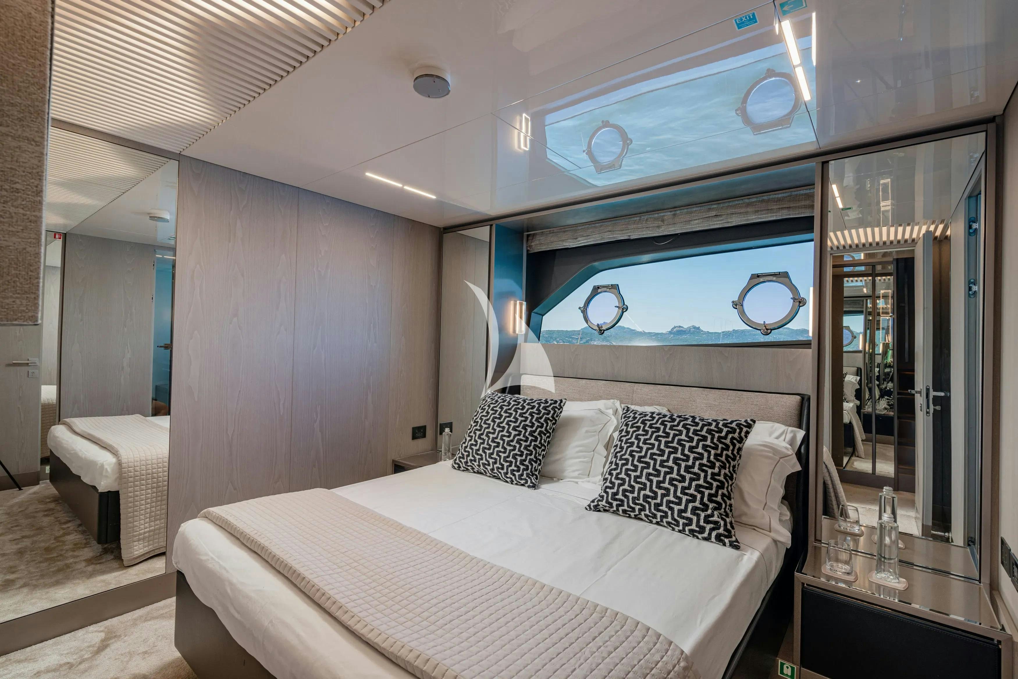 a bedroom with a large mirror aboard E3 Yacht for Charter