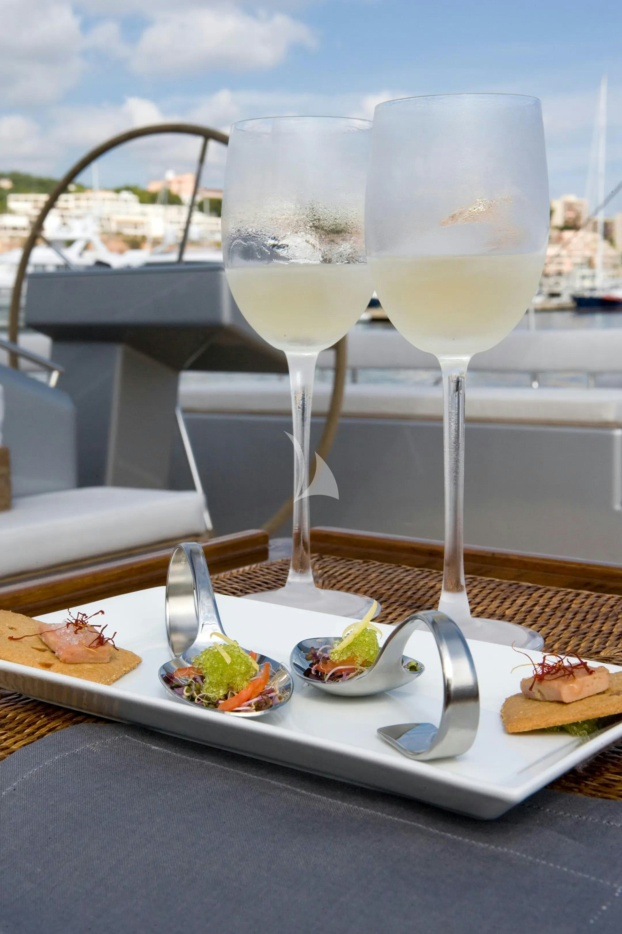 a table with food and glasses on it aboard MYSTERE Yacht for Charter