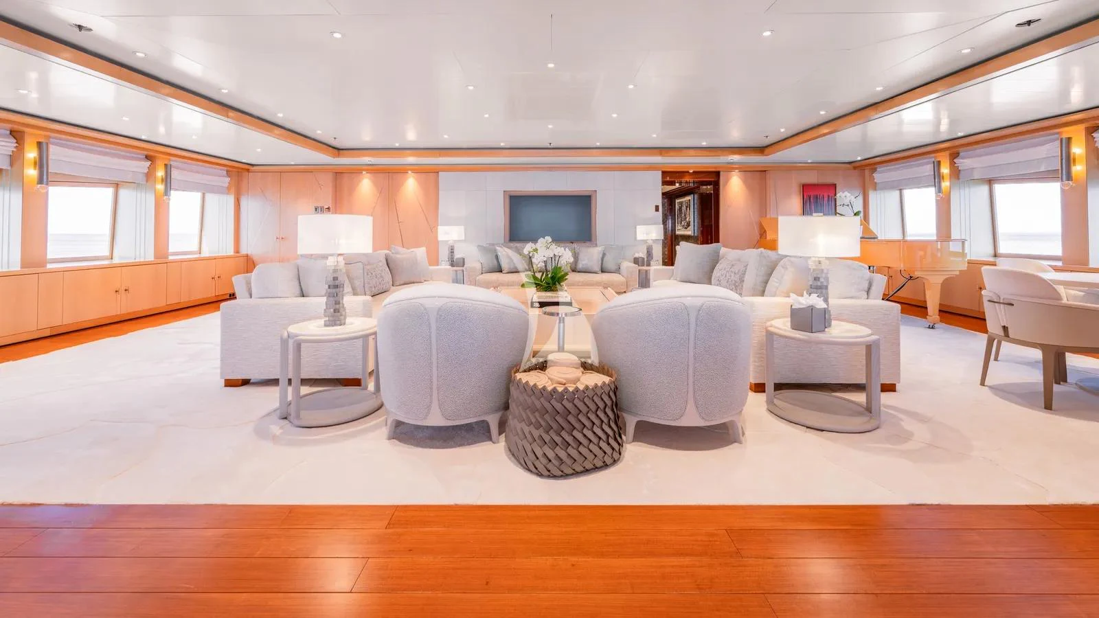 a living room with a large white couch and a round coffee table aboard BATELLO Yacht for Charter