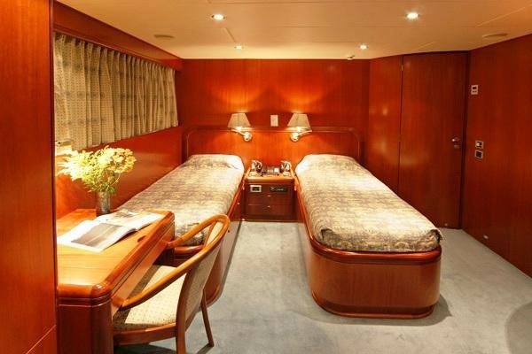 a room with a bed and a desk aboard ALCOR Yacht for Charter