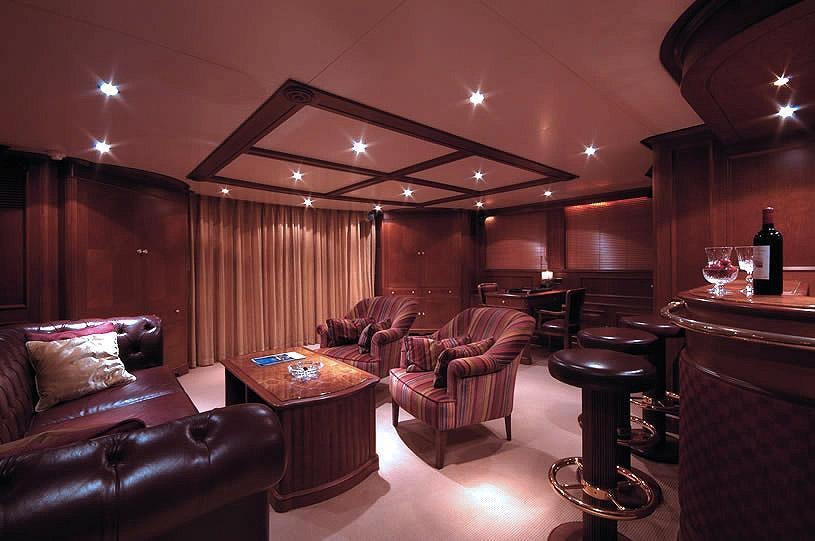 a room with a couch and a table and chairs aboard INOUIS Yacht for Charter