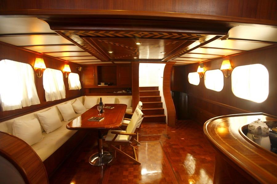 a room with a couch and a table and chairs aboard ESMA SULTAN Yacht for Charter