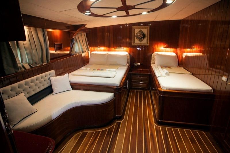 a room with a bed and a couch aboard ESMA SULTAN Yacht for Charter