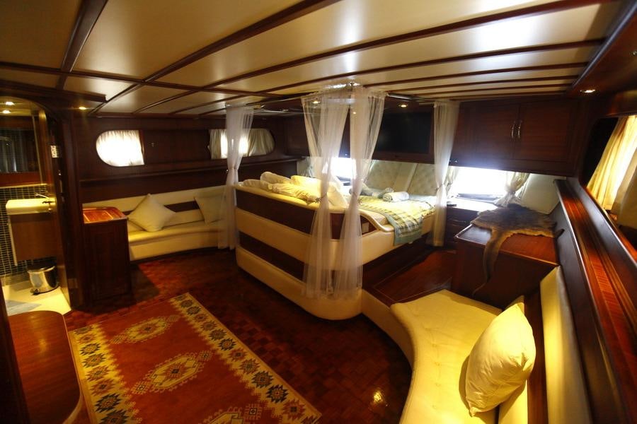 a room with a bed and a desk aboard ESMA SULTAN Yacht for Charter
