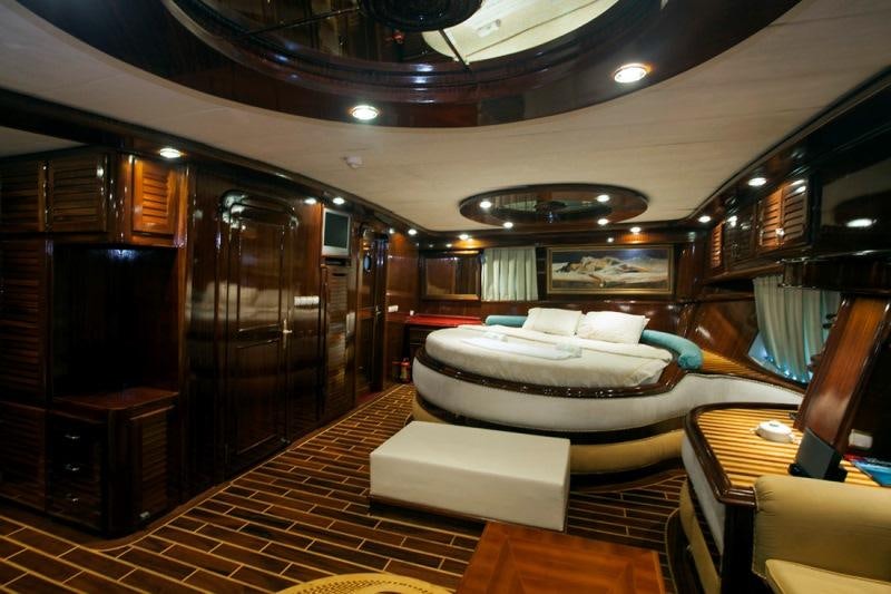a room with a bed and a table aboard ESMA SULTAN Yacht for Charter