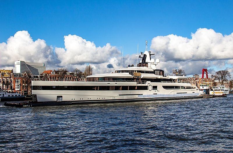 a large white boat in a harbor aboard LADY S Yacht for Charter