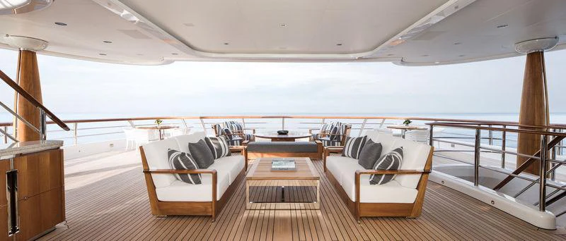 a room with a couch and a table and a large window aboard AQUILA Yacht for Charter