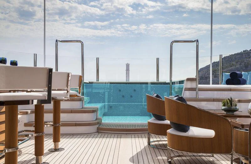 a deck with a view of the ocean and the ocean aboard AQUILA Yacht for Charter
