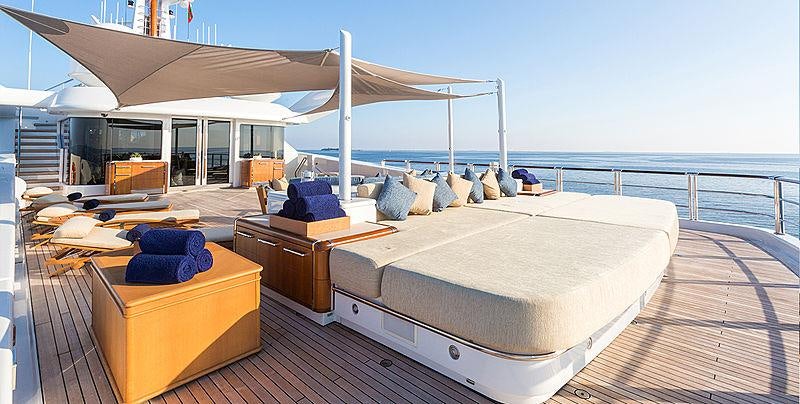 a large bed on a deck aboard WHEELS Yacht for Charter