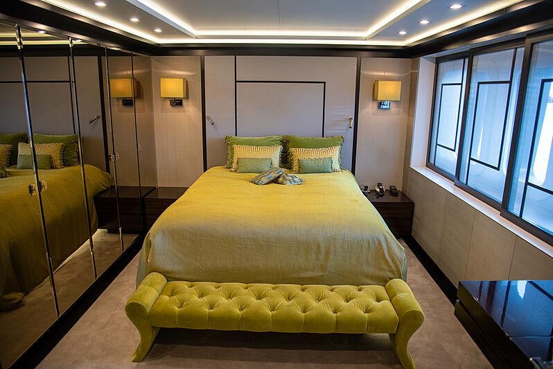 a room with a bed and a desk aboard LADY VERA Yacht for Charter