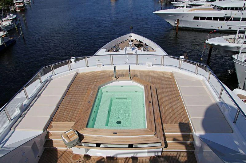 a deck with a pool and boats aboard CLOUDBREAK Yacht for Charter