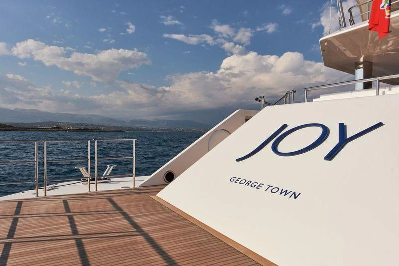 a white boat on a dock aboard JOY Yacht for Charter