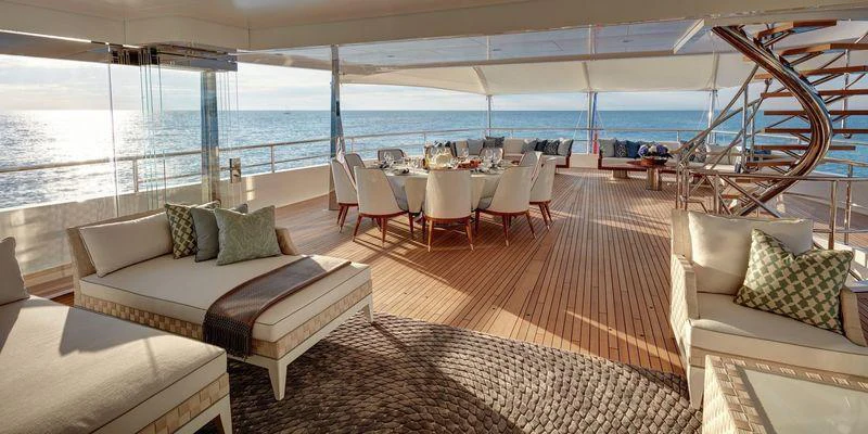 a room with a couch and a table and chairs aboard JOY Yacht for Charter
