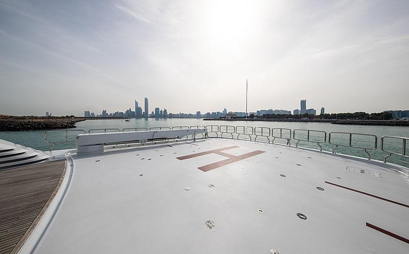 a rooftop with a large building in the background aboard NOMAD Yacht for Charter