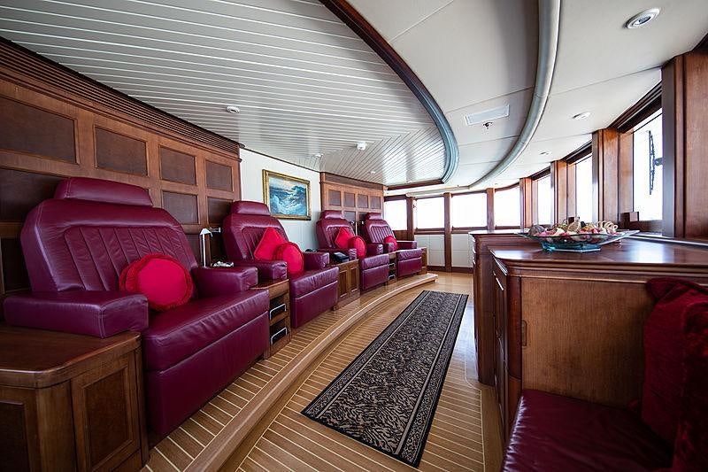 a large room with a couch and a table aboard NOMAD Yacht for Charter