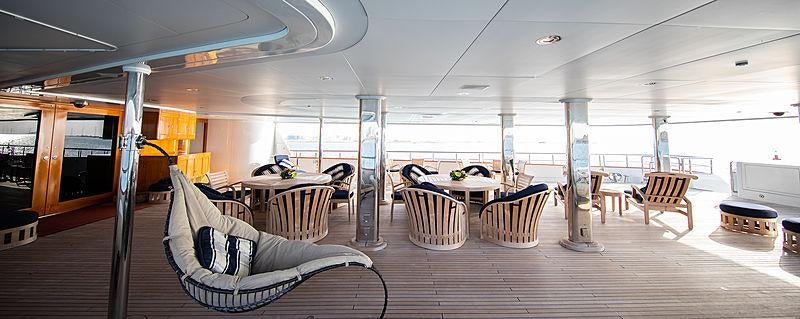 a large room with tables and chairs aboard NOMAD Yacht for Charter