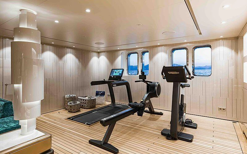 a room with a large mirror and a desk with a laptop on it aboard SOARING Yacht for Charter