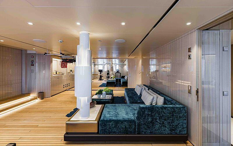 a large living room with a large white column aboard SOARING Yacht for Charter