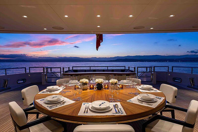 a large table with plates and chairs aboard SOARING Yacht for Charter