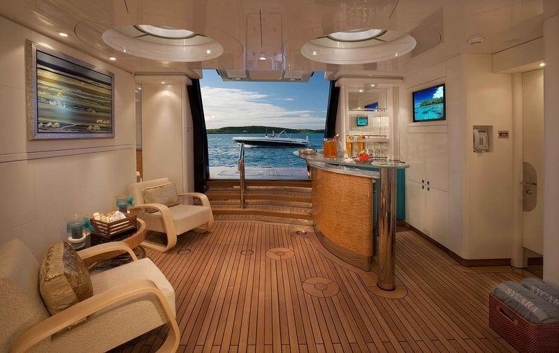 a living room with a table and chairs aboard SYCARA V Yacht for Charter