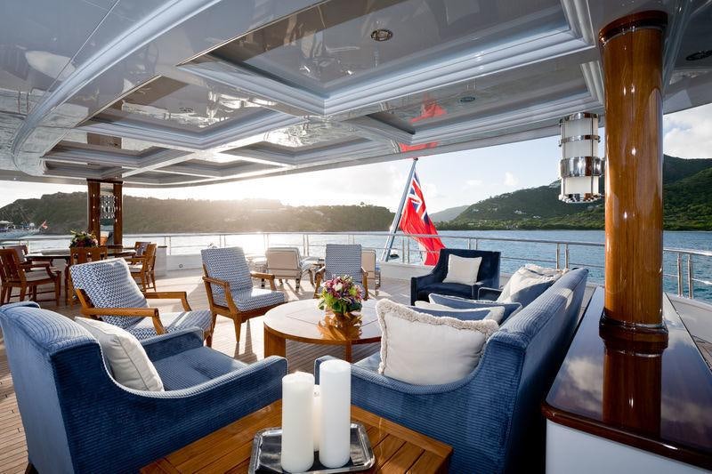 a room with a table chairs and a large window aboard INVICTUS Yacht for Charter