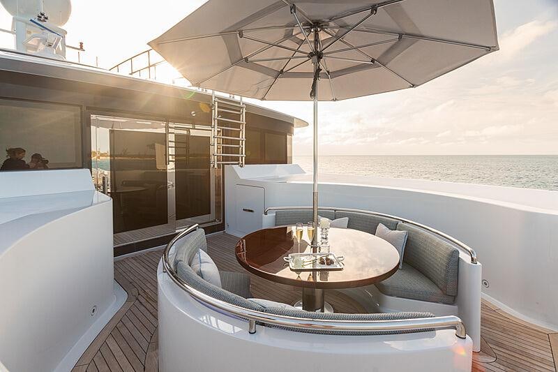 a table and a chair on a boat aboard JOIA THE CROWN JEWEL Yacht for Charter