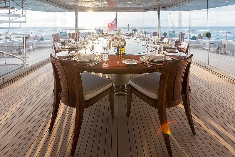 a table set for a dinner aboard JOIA THE CROWN JEWEL Yacht for Charter