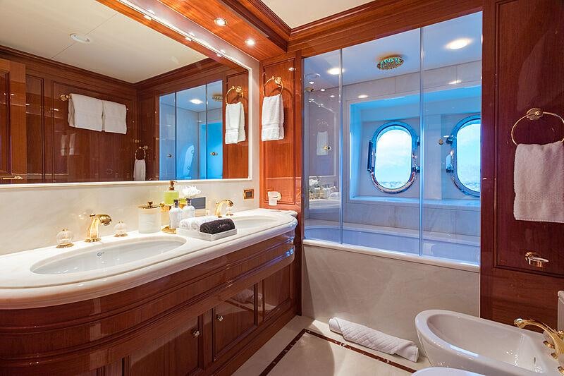 a bathroom with a large mirror aboard JOIA THE CROWN JEWEL Yacht for Charter