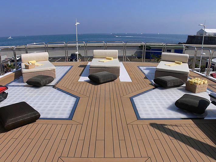 a deck with a table and chairs on it aboard MAGNA GRECIA Yacht for Charter