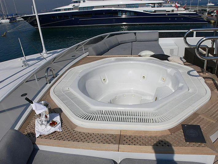 a white boat on a deck aboard MAGNA GRECIA Yacht for Charter