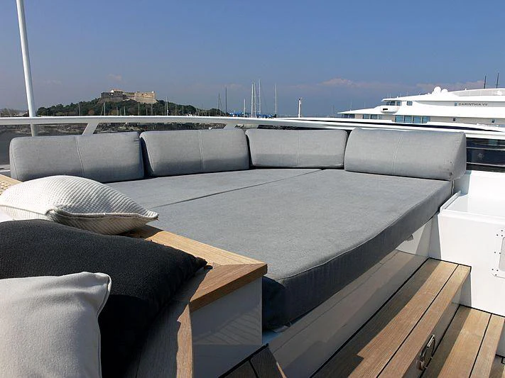 a couch with a pillow on it aboard MAGNA GRECIA Yacht for Charter