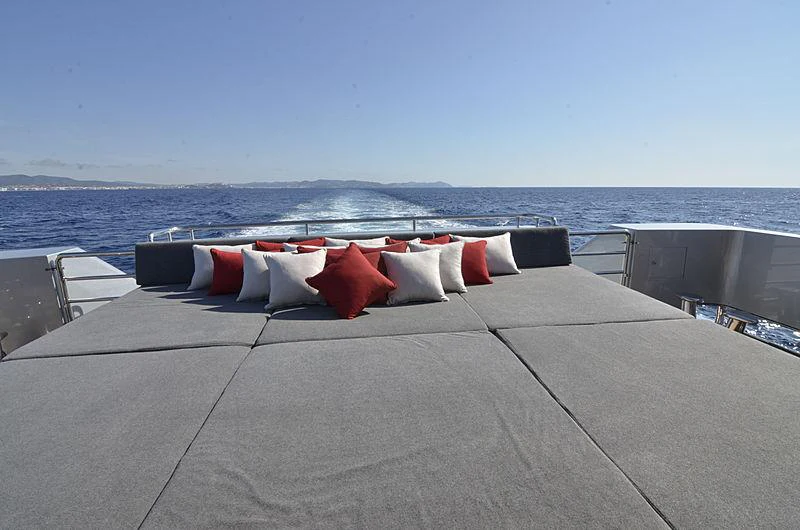 a rooftop with pillows and a body of water in the background aboard MAGNA GRECIA Yacht for Charter