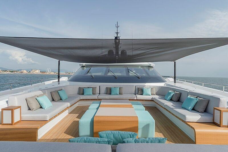 a large white house with a large balcony and a large pool aboard UTOPIA IV Yacht for Charter